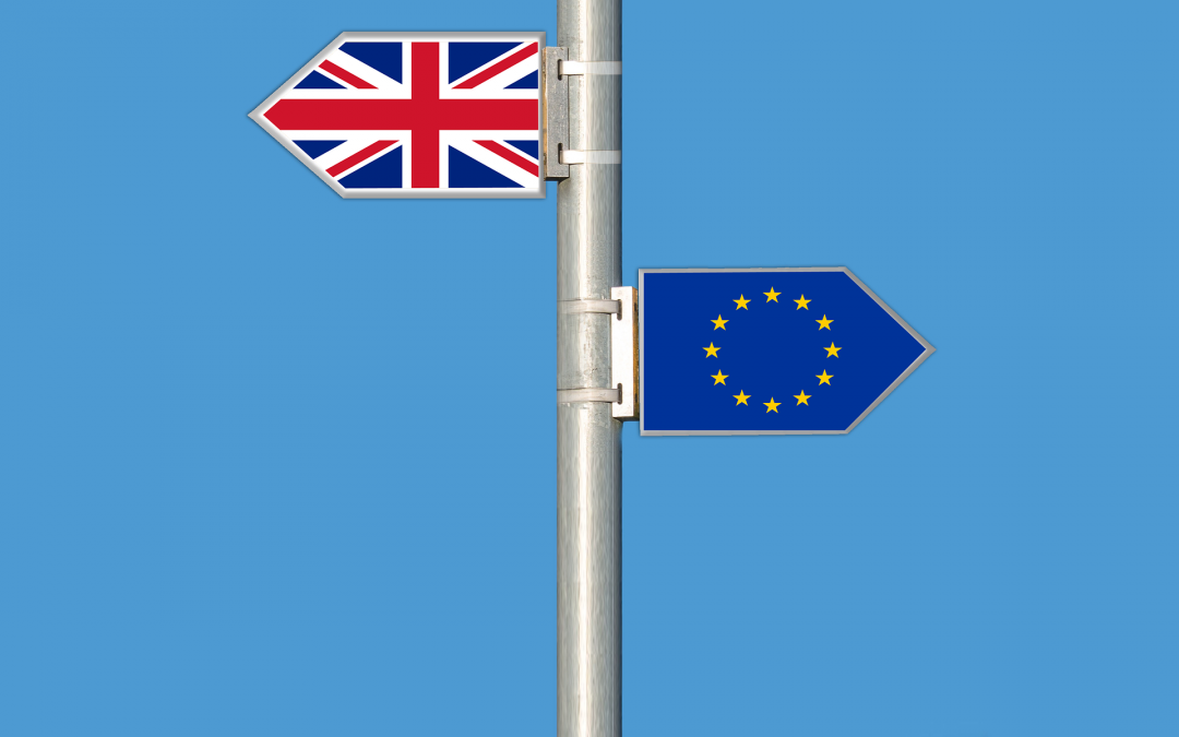 Sign post with UK flag pointing in one direction, and EU flag in another